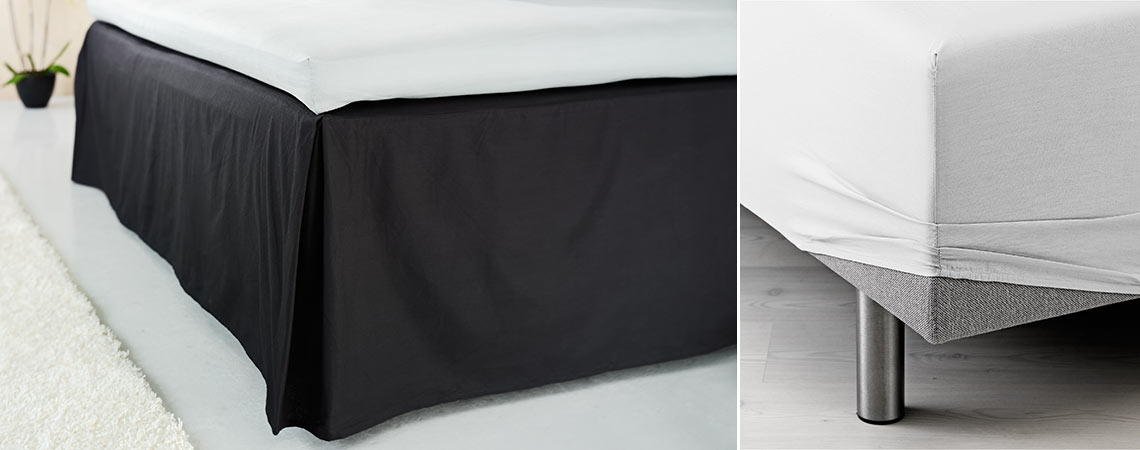 Crna plahta na krevetu i bijela plahta s gumicom navučena na ugao kreveta